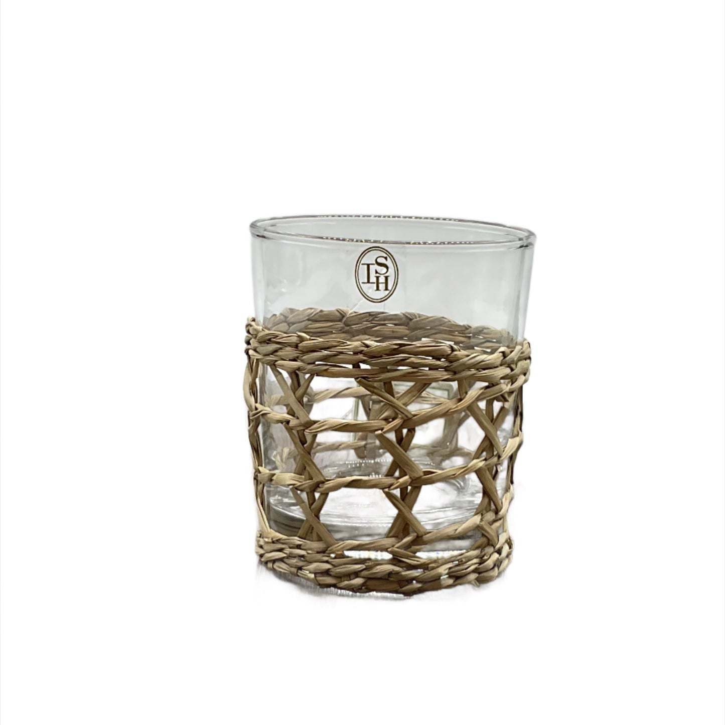 A clear highball glass with a natural woven seagrass wrap