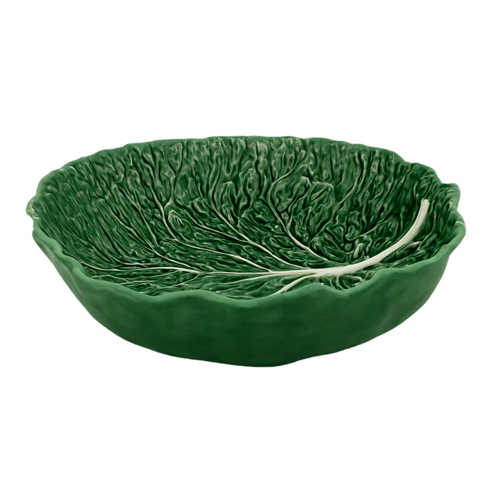 A large ceramic salad bowl with a green color and a leaf pattern resembling a cabbage.