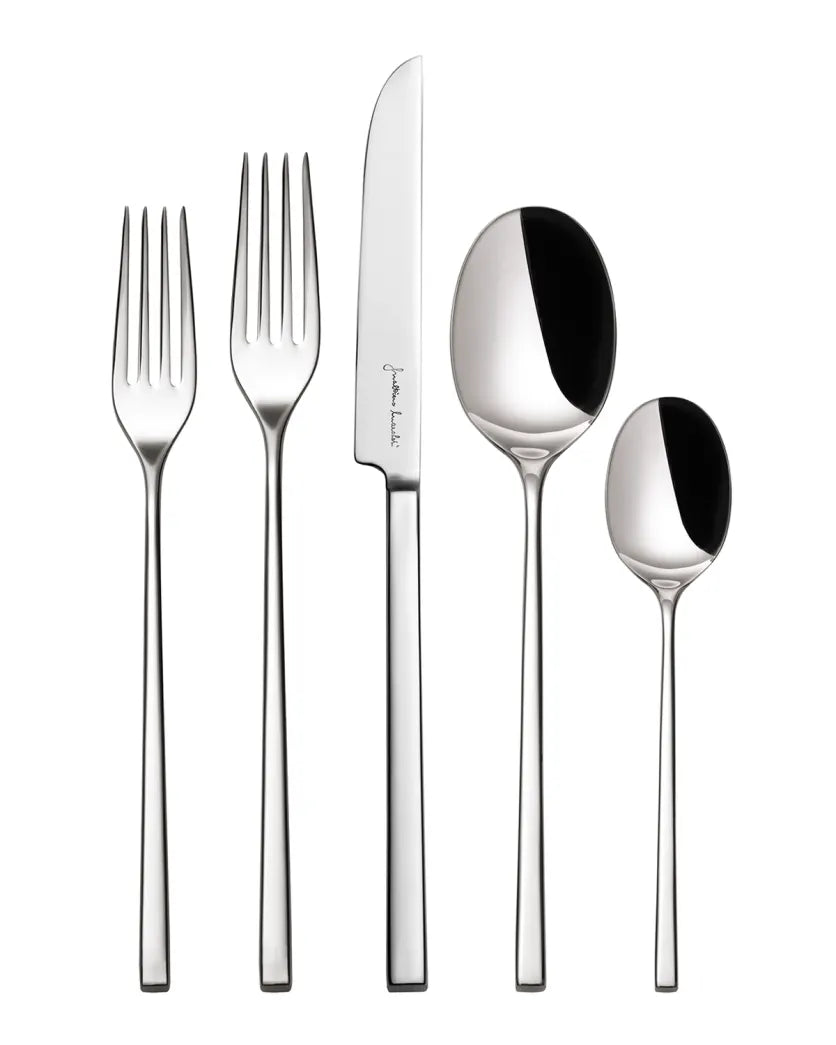 A 5-piece flatware set including a dinner knife, dinner fork, salad/dessert fork, soup spoon, and teaspoon with a minimalist design, made of polished stainless steel.
