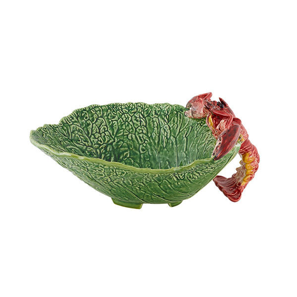 A green ceramic salad bowl with a leaf pattern and a decorative red lobster on the side.