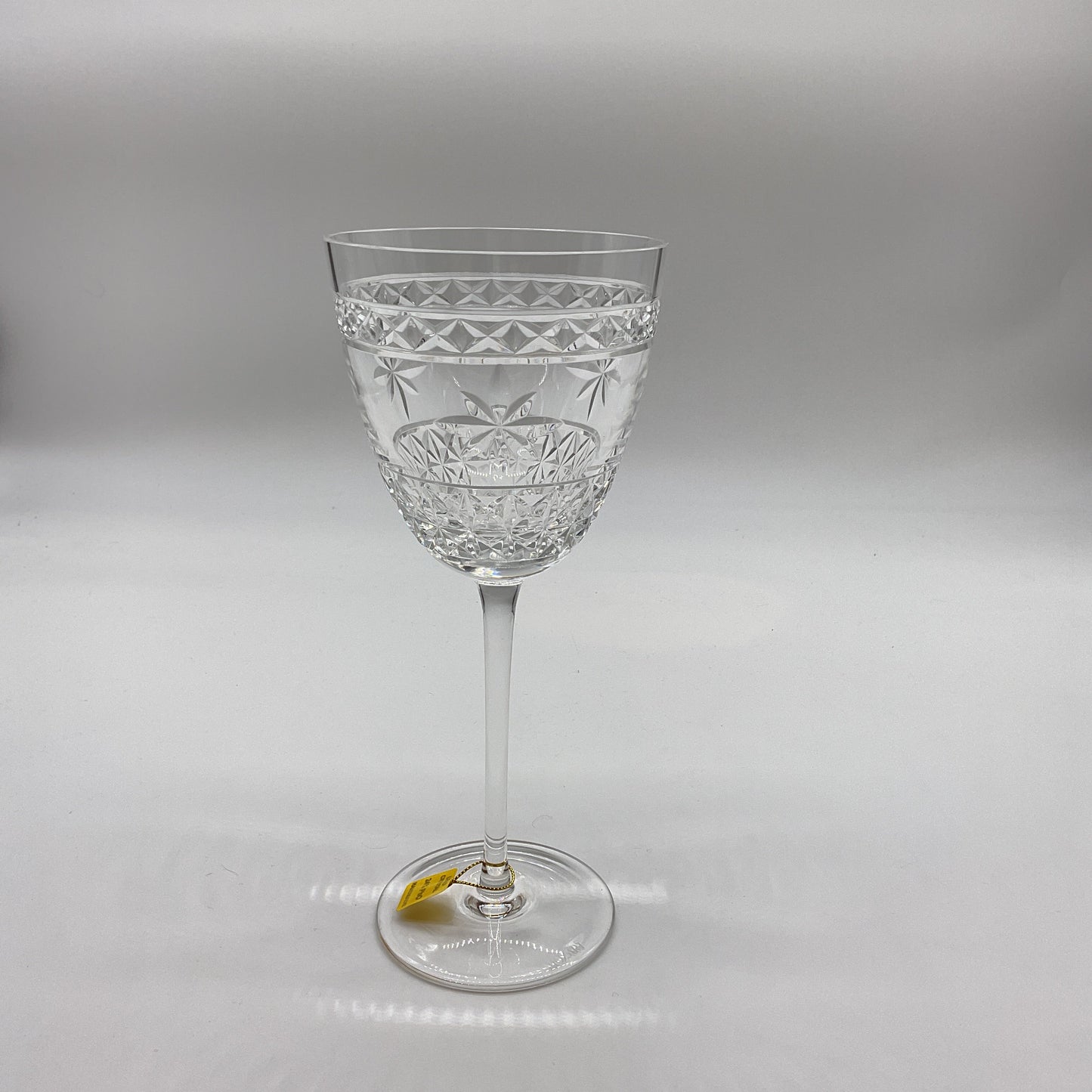 A clear crystal red wine glass with a geometric pattern.