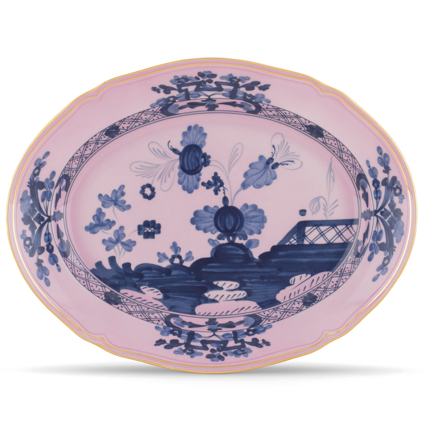 An oval-shaped porcelain platter with a blue floral pattern on a pink background, featuring gold threading accents along the rim.