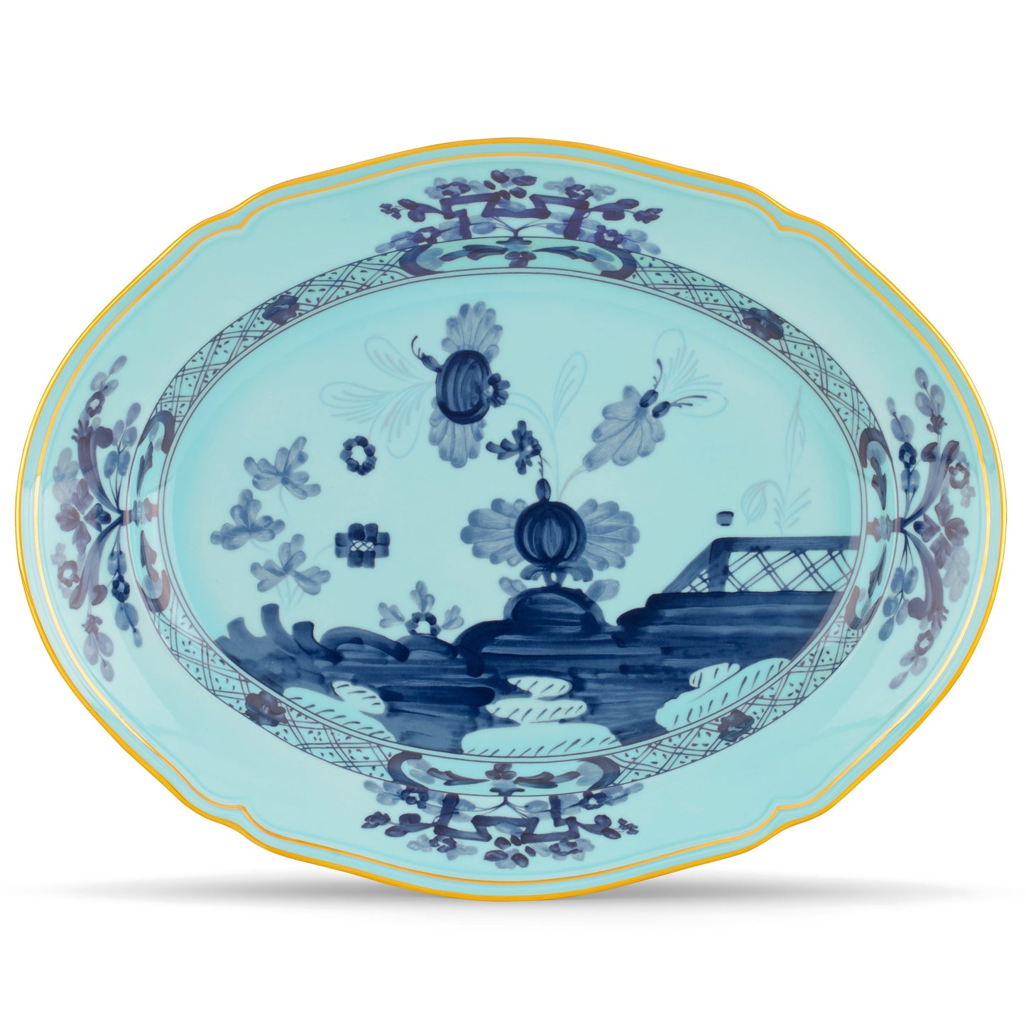 An oval-shaped, fine porcelain platter with a blue carnation motif and gold threading on an iris blue background.