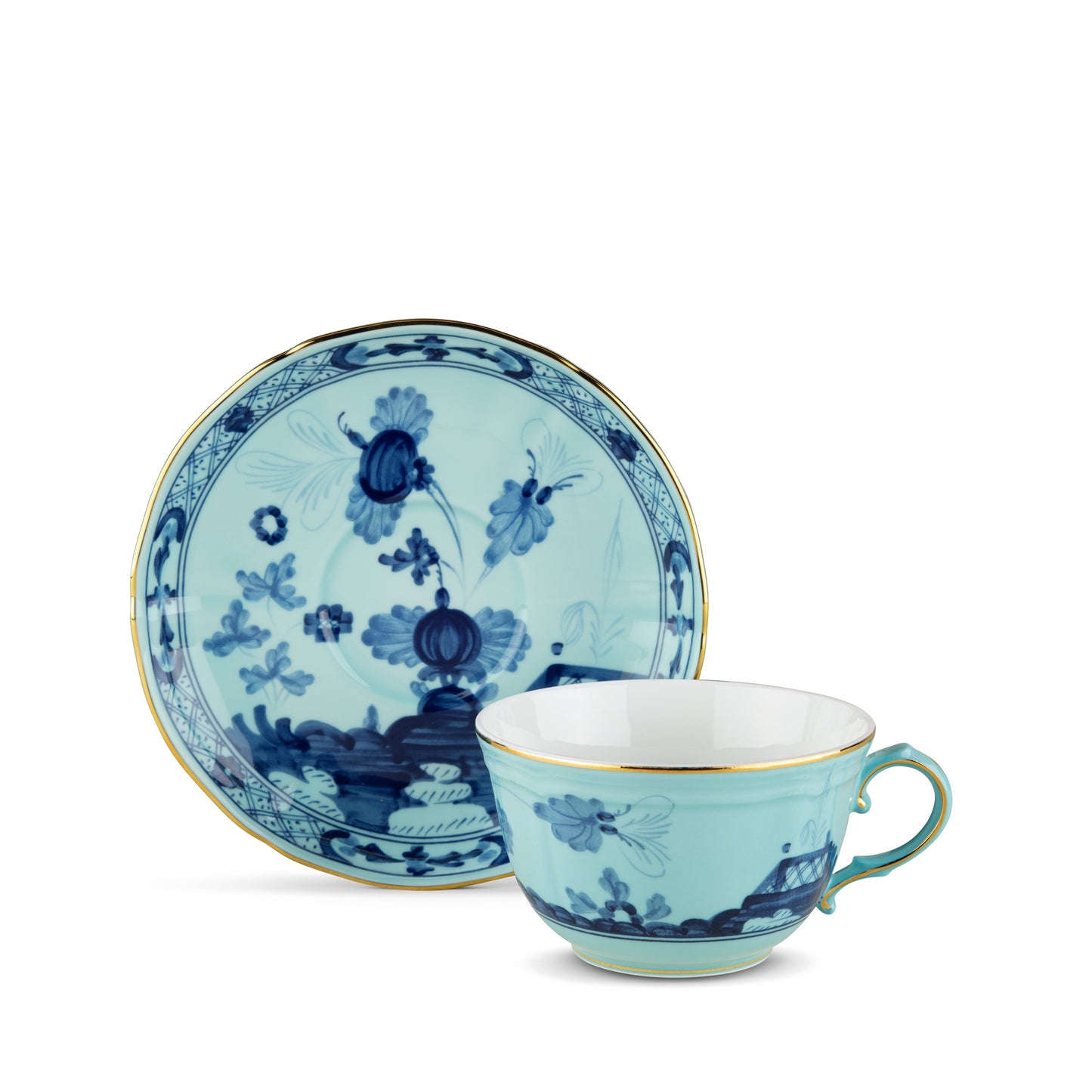 A blue and white floral patterned tea cup and saucer set with gold accents.