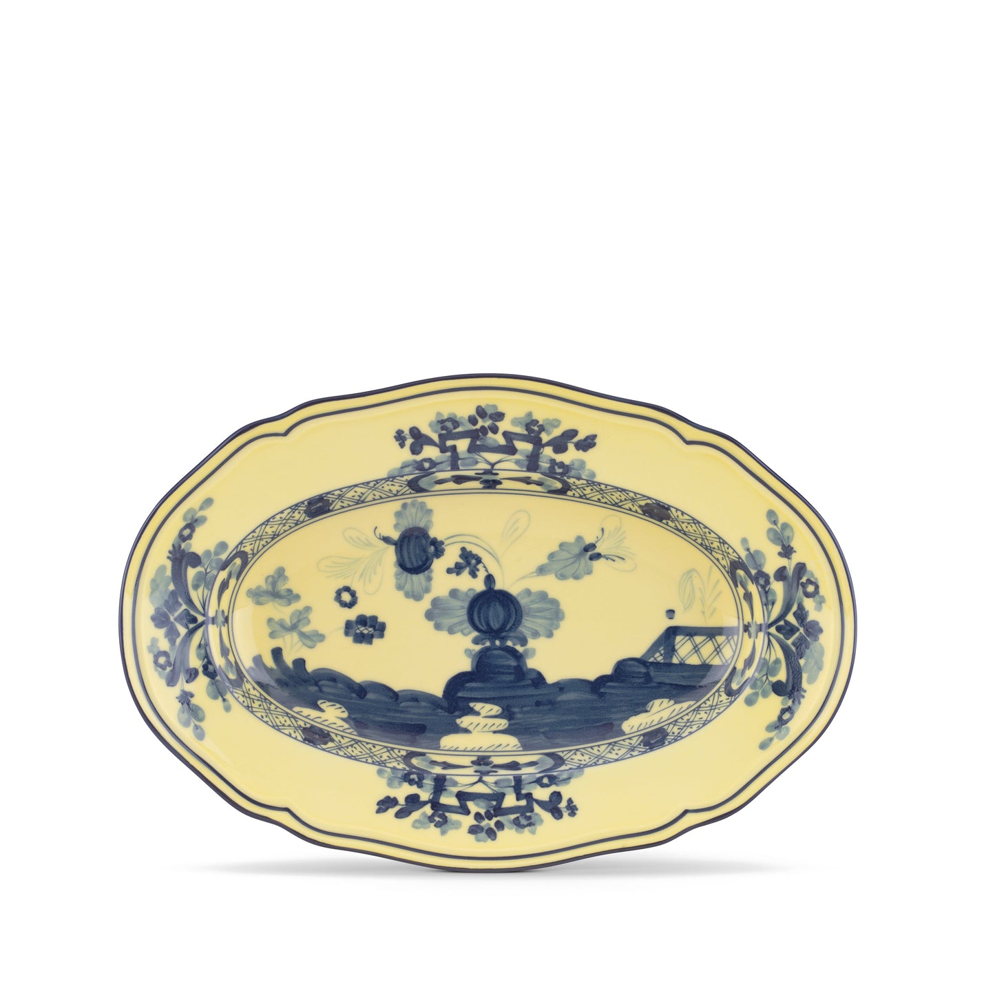 An oval-shaped porcelain pickle dish with a yellow border and blue floral patterns, from the Oriente Italiano collection by Ginori 1735.