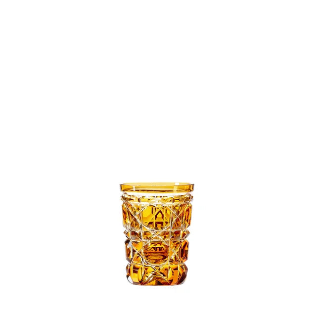 An engraved royal crystal shot glass with a amber color accent