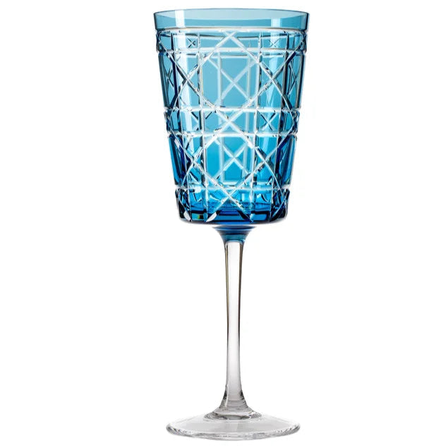 A blue crystal water glass with a geometric engraved pattern on the surface.
