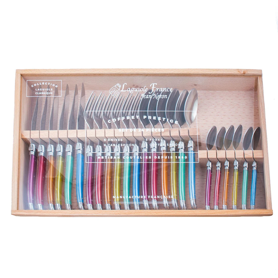 A 24-piece Laguiole flatware set with colorful acrylic handles displayed in a wooden box with glass lid.