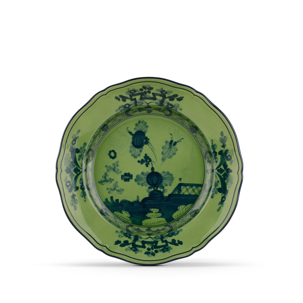 A green porcelain dessert plate with floral patterns and a malachite design, from the Oriente Italiano collection.