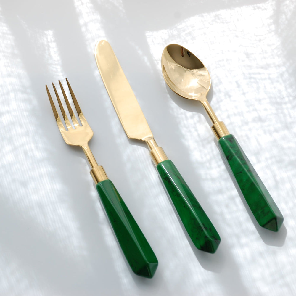 A set of flatware consisting of a fork, knife, and spoon with gold metal finishes and malachite green handles.