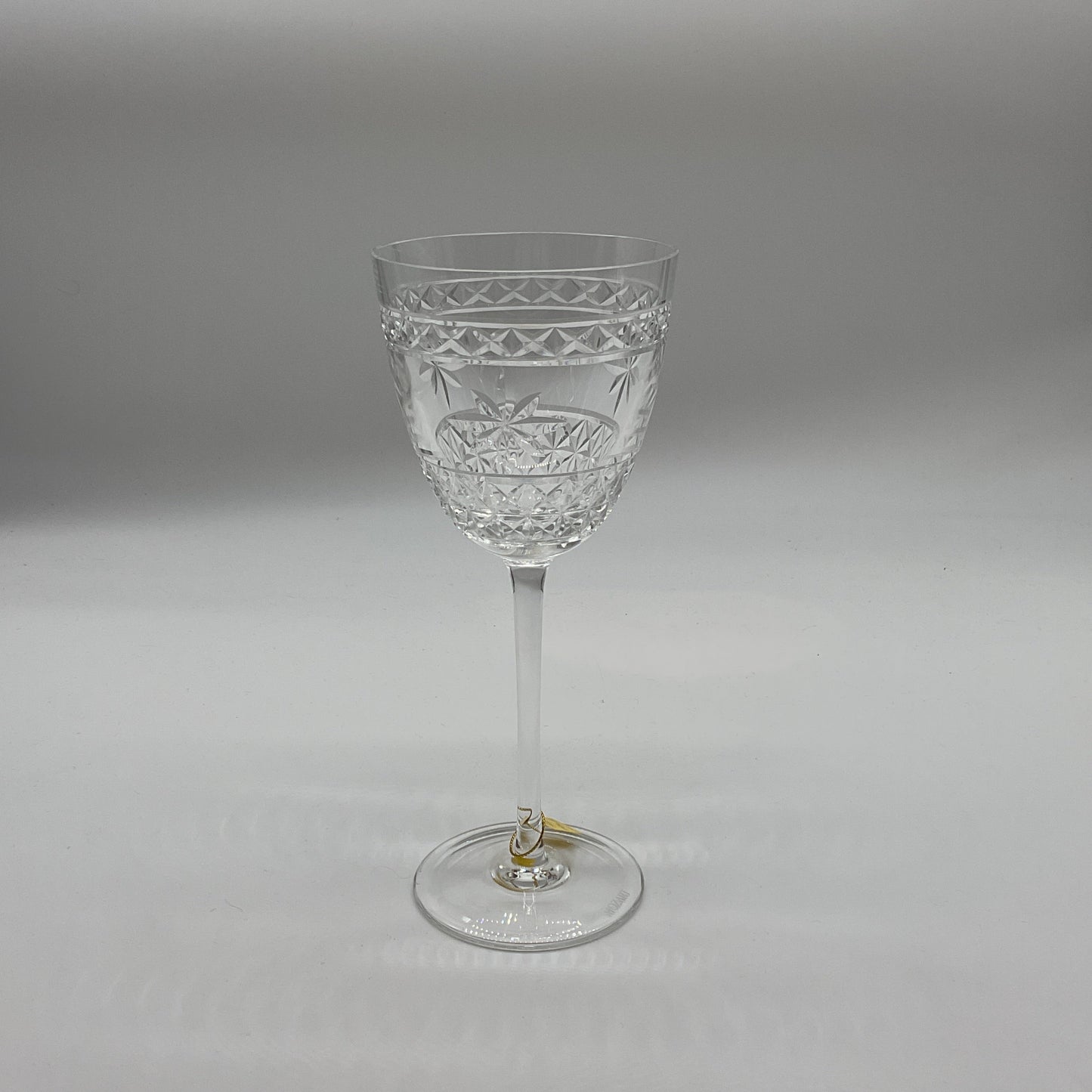 A clear crystal red wine glass with a geometric pattern.