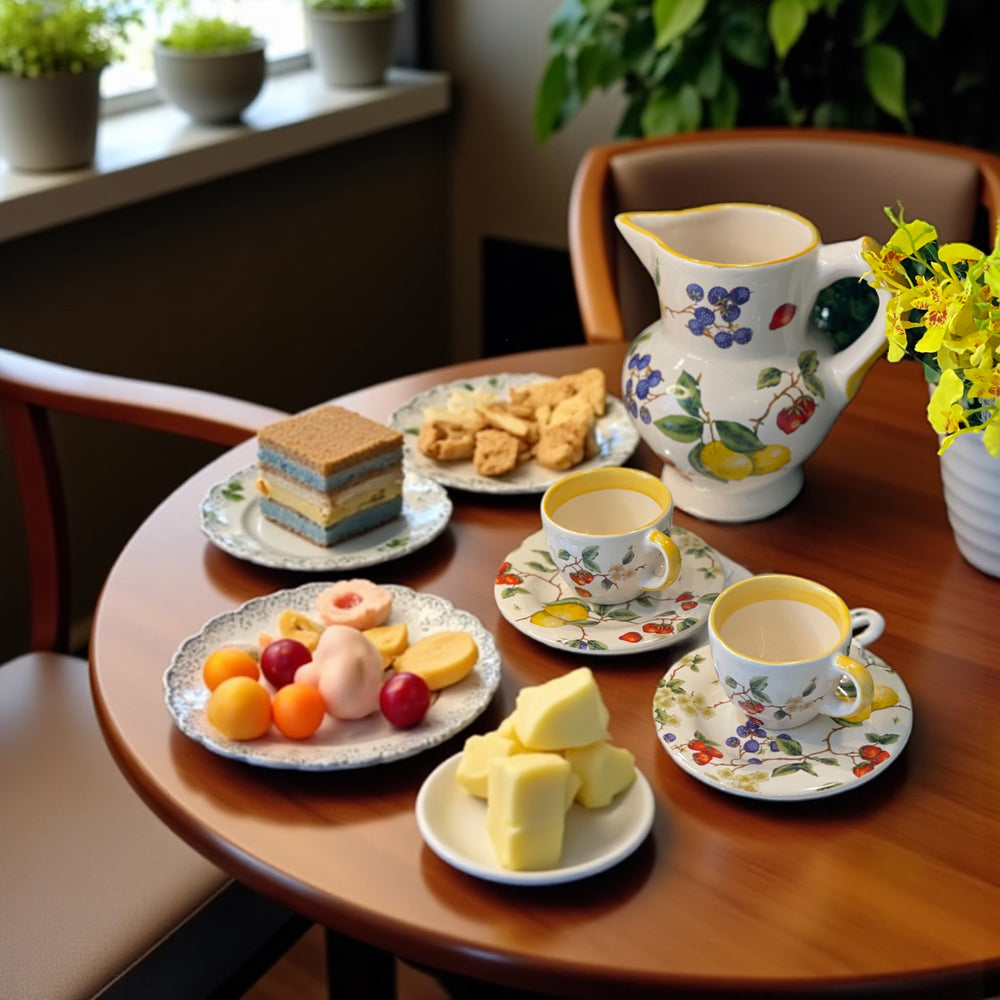 tea cup with yellow trim and floral patterns, accompanied by a matching saucer.