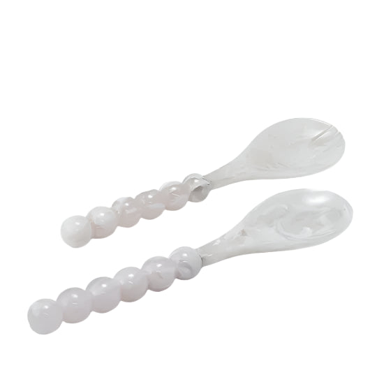 Two white salad servers with blue marbled heads and pearl-like beaded handles.
