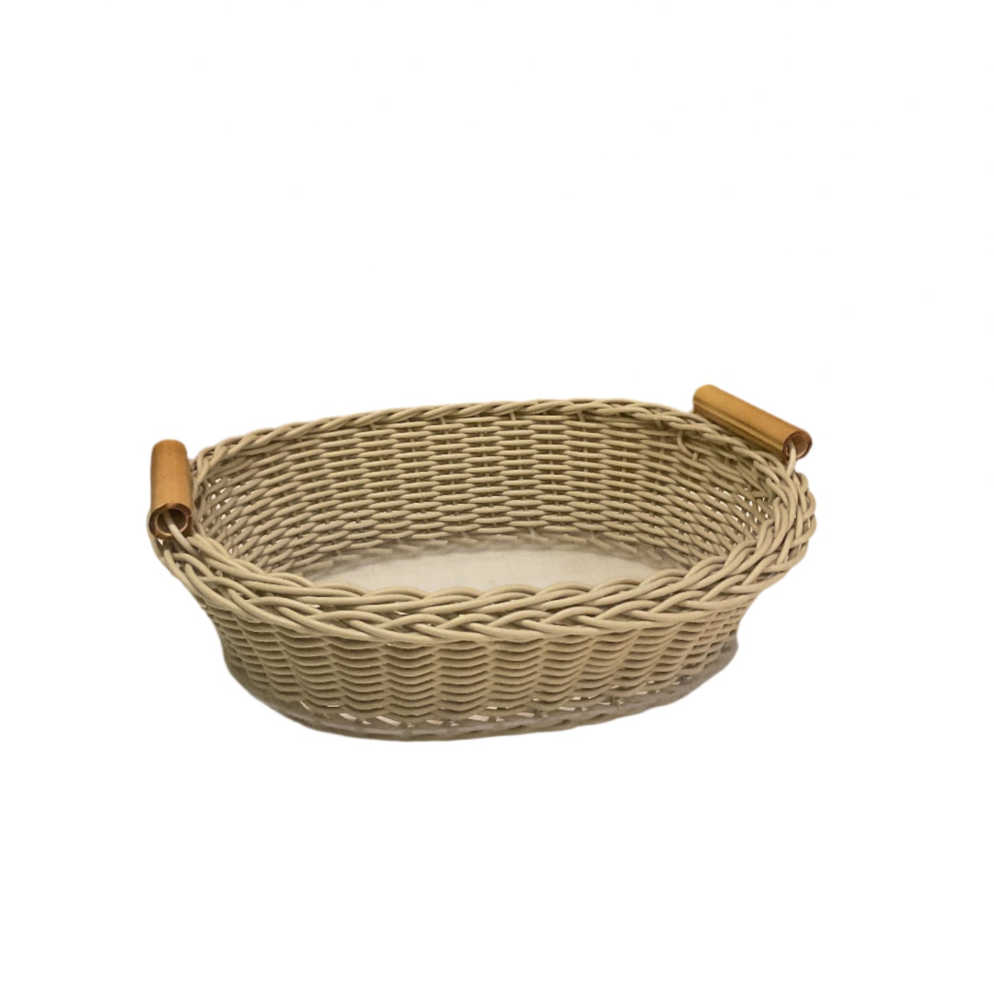 Oval wicker basket with beige color and bamboo handles.