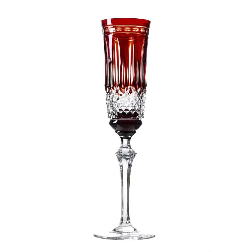 A red crystal champagne glass with a clear body and red overlay on the top