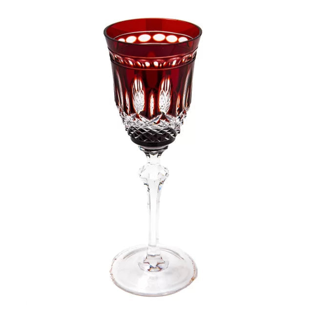 A red crystal liquor glass with a geometric pattern on the stem and a clear crystal design on the bowl.