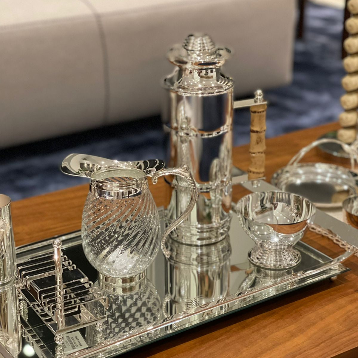 A silver-plated Sheffield Plate thermal carafe with a natural bamboo handle.