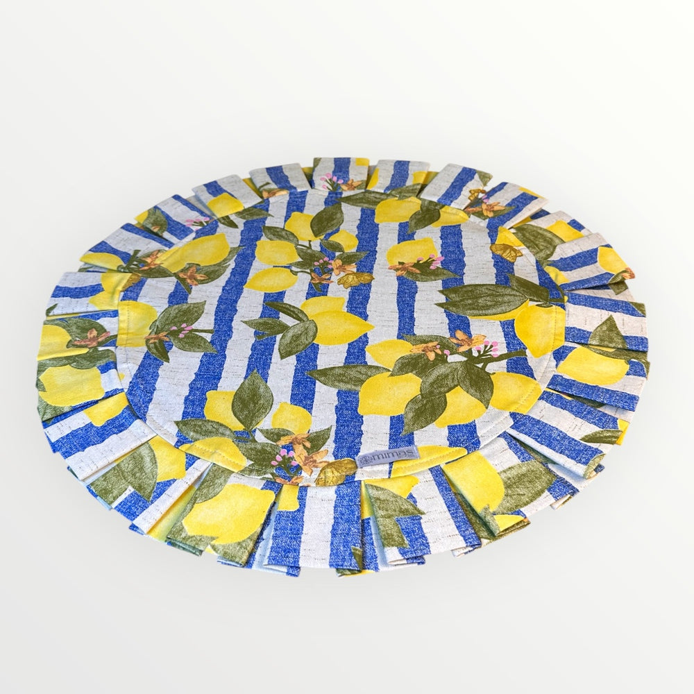 Round table mat with lemon and blue striped pattern on a white background