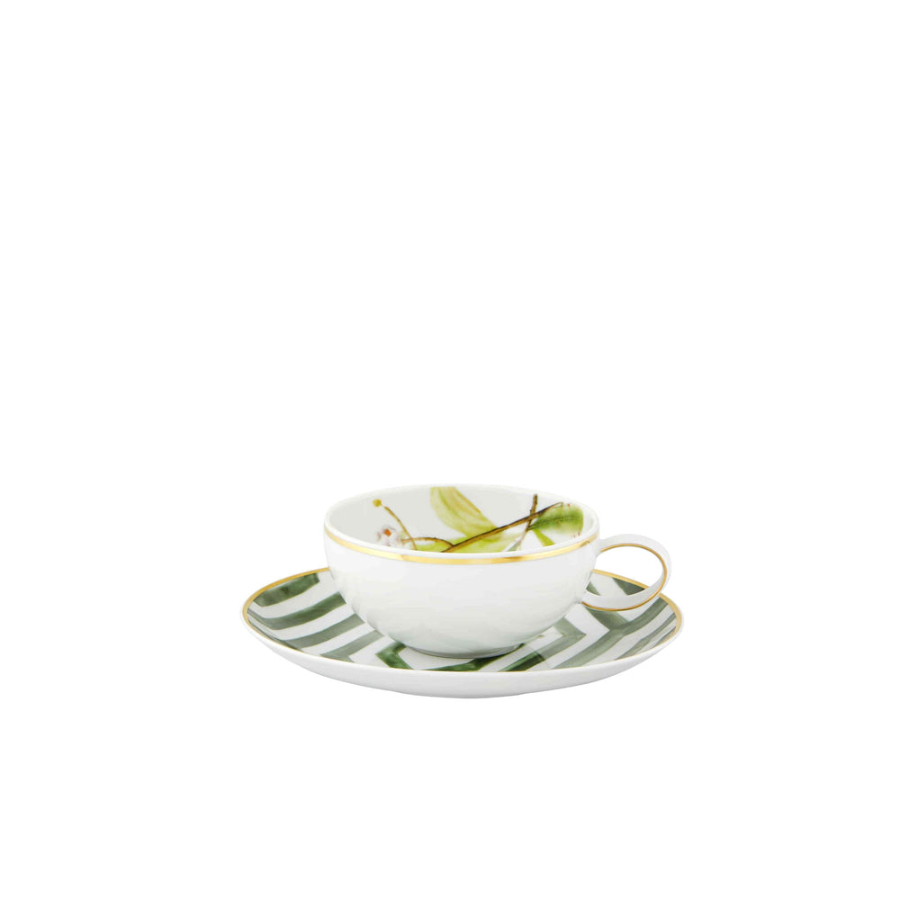 A white tea cup with green stripes and gold detailing on the saucer, part of the Vista Alegre Amazonia Collection.