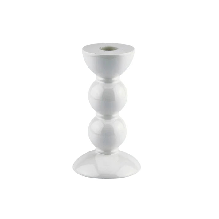 A medium white lacquered bobbin shaped candlestick with a smooth finish and polished surface.